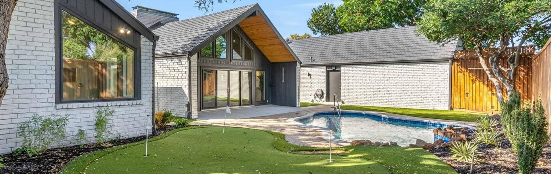 Backyard pool and putting green at a custom home