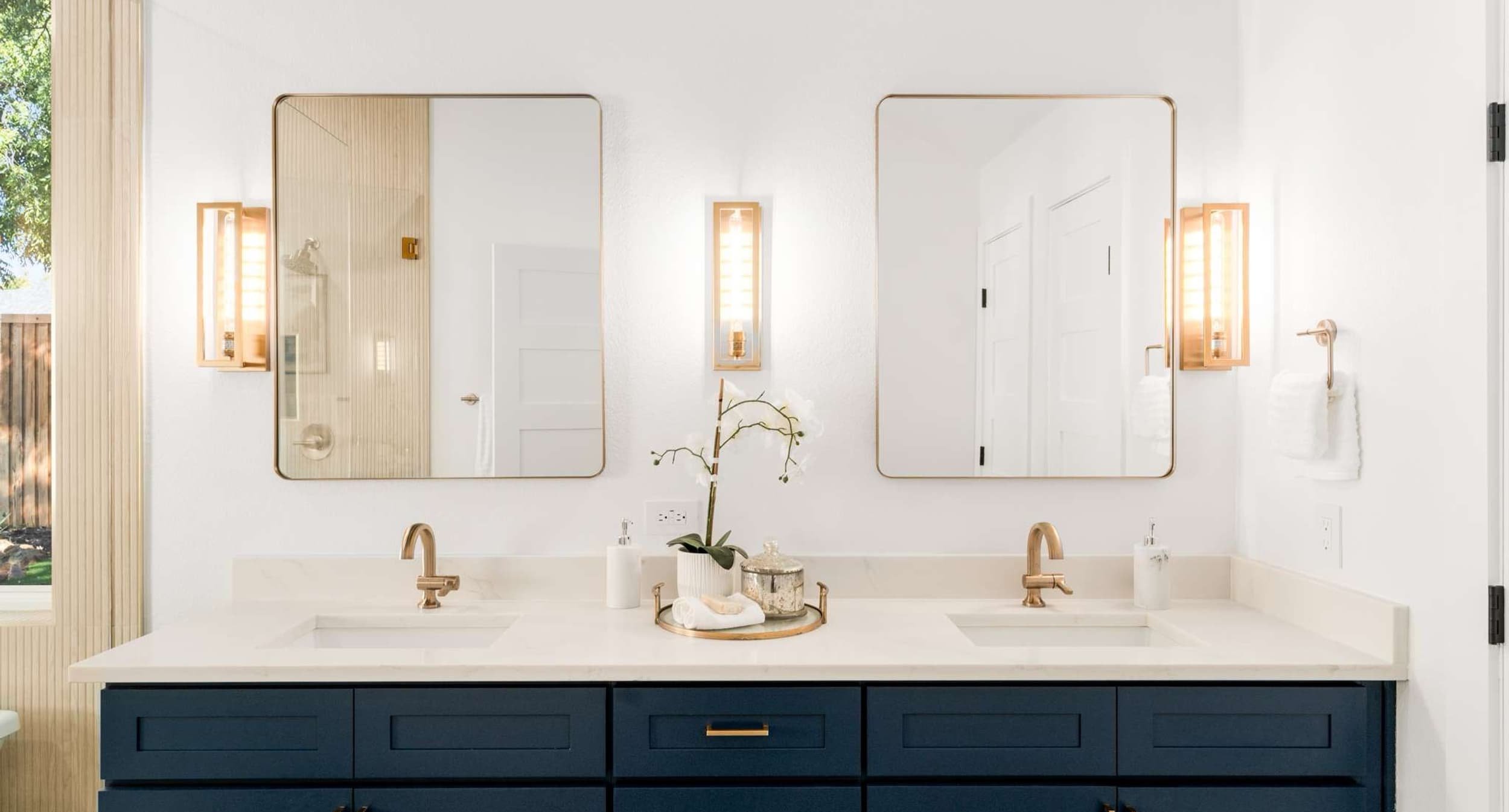 Renovated kitchen with dark cabinetry and gold hardware, completed by Buffalo Ridge Construction